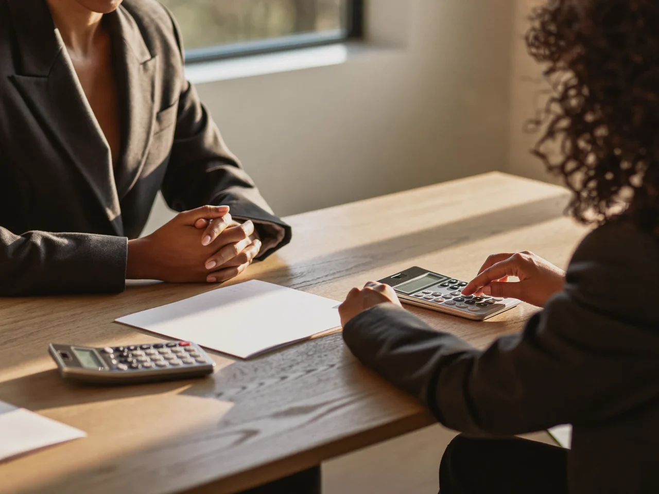 Illustration of an adviser and resident talking through an entitlement check at a table