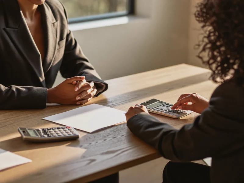 Illustration of an adviser and resident talking through an entitlement check at a table